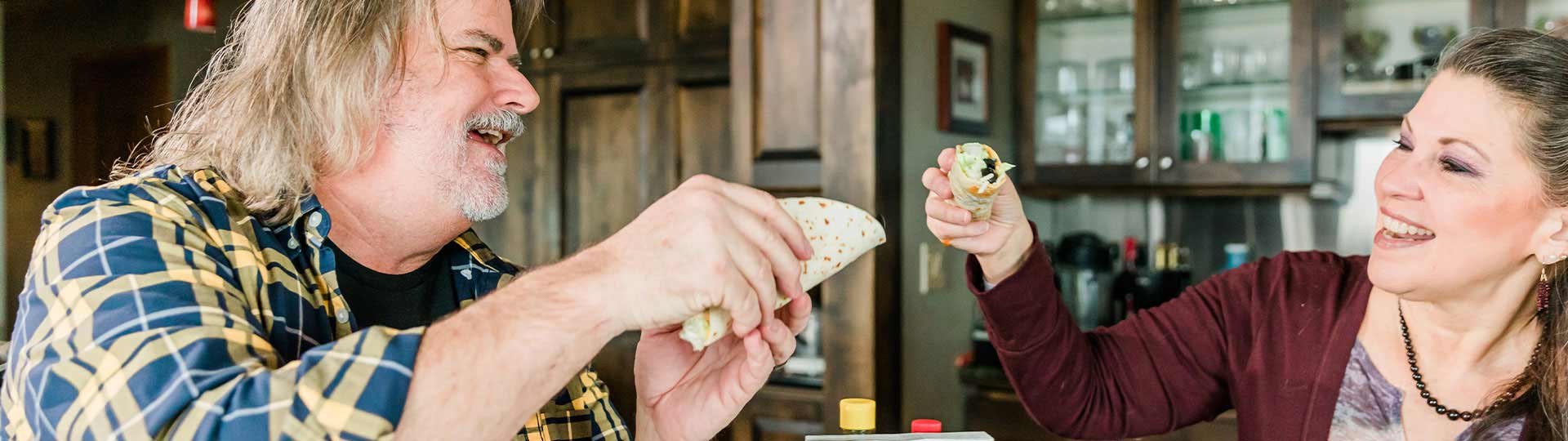 Man and woman eating tacos